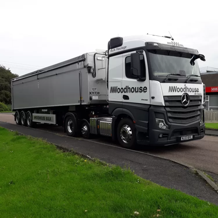 Modern M.Woodhouse Transport Ltd truck parked up.