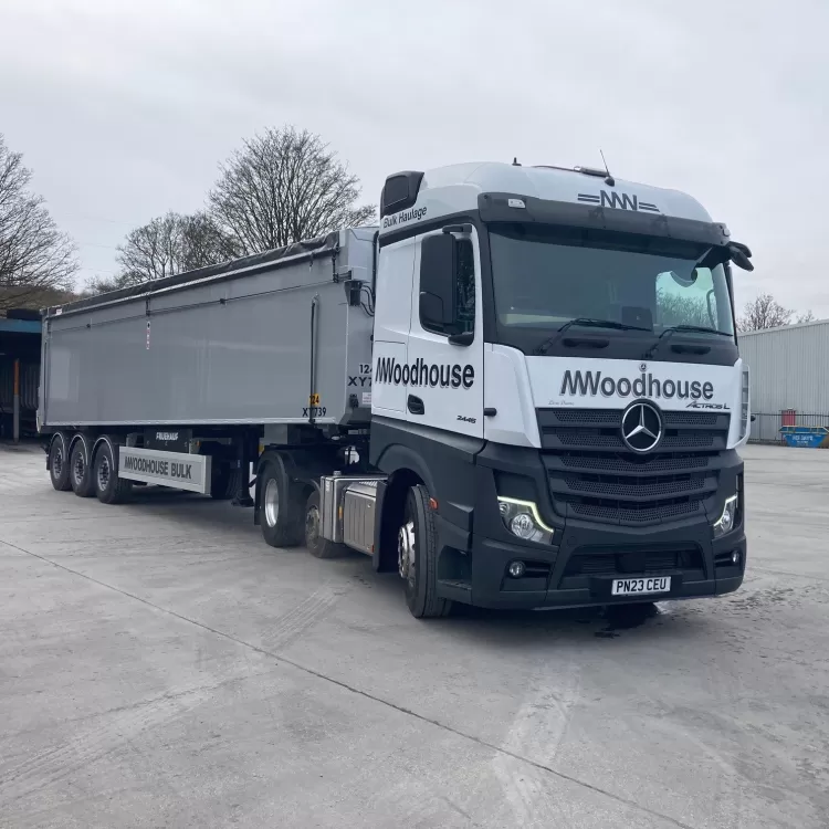 A modern M.Woodhouse Transport Ltd Mercedes truck at the depot.