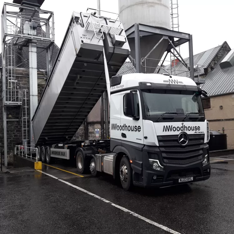 An M.Woodhouse Transport Ltd tipper truck in operation.